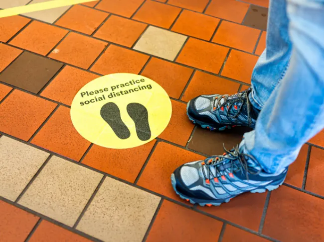 social distancing sign on floor
